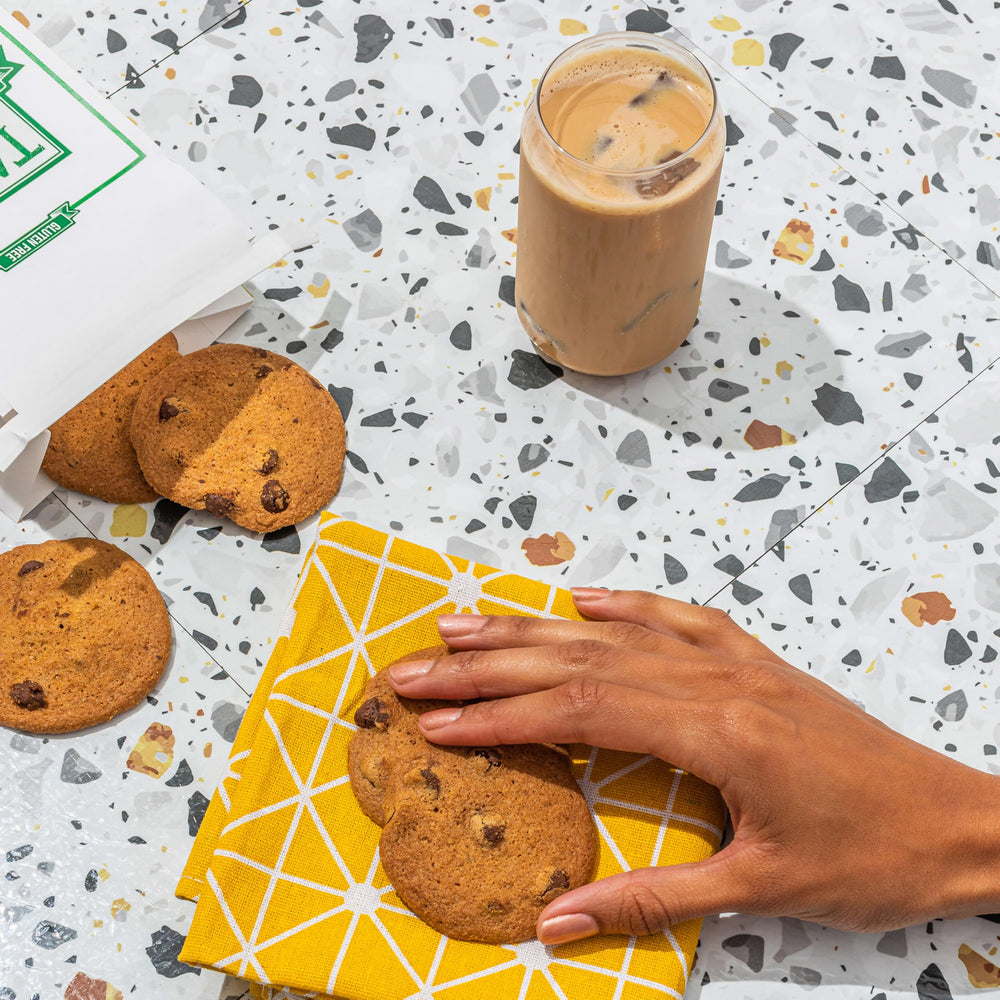 Close-up of Tate's gluten-free lemon cookies with bright zest.