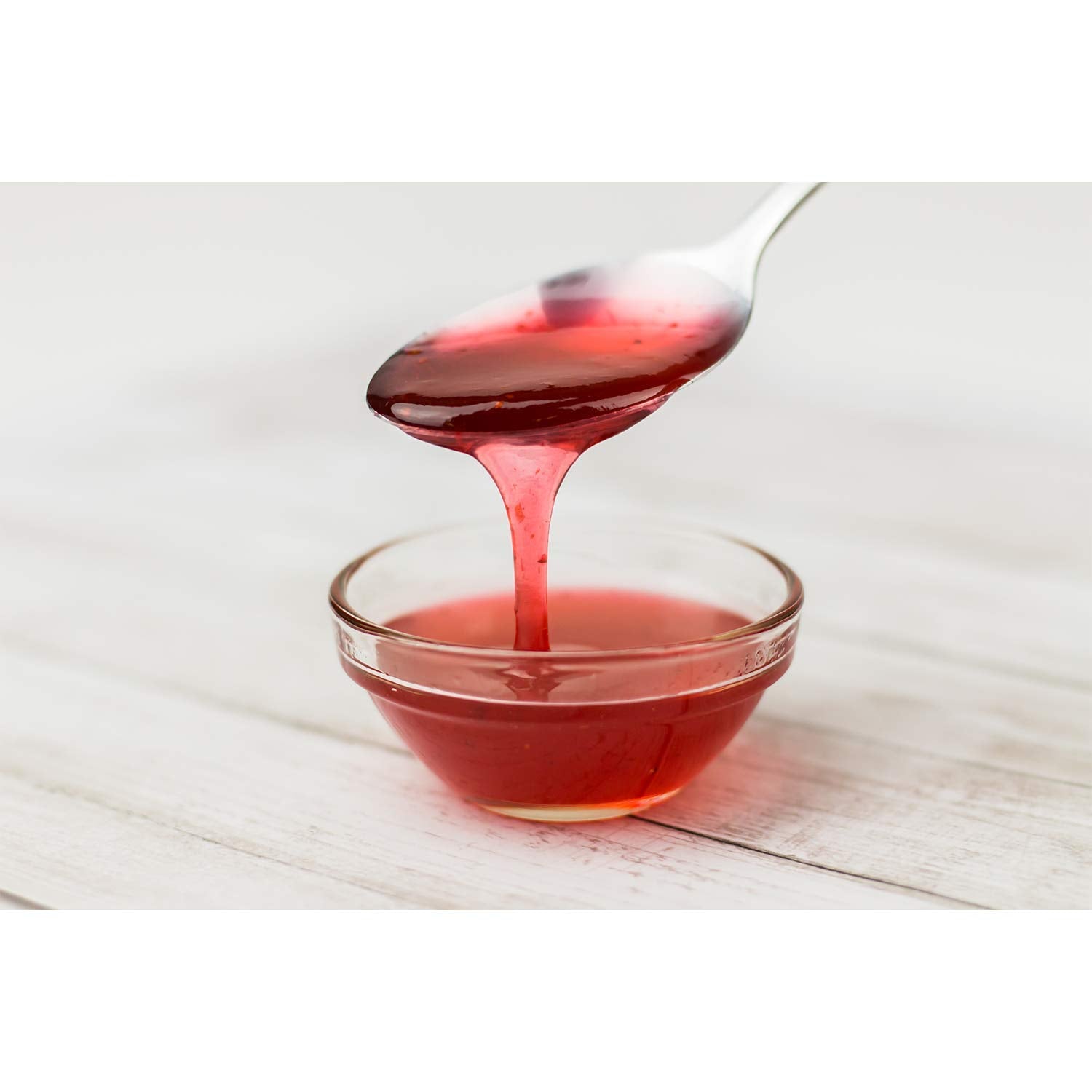 Tea Zone strawberry syrup over ice cream for dessert topping.