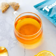 Teatulia Chamomile tea being brewed in a warm cup.