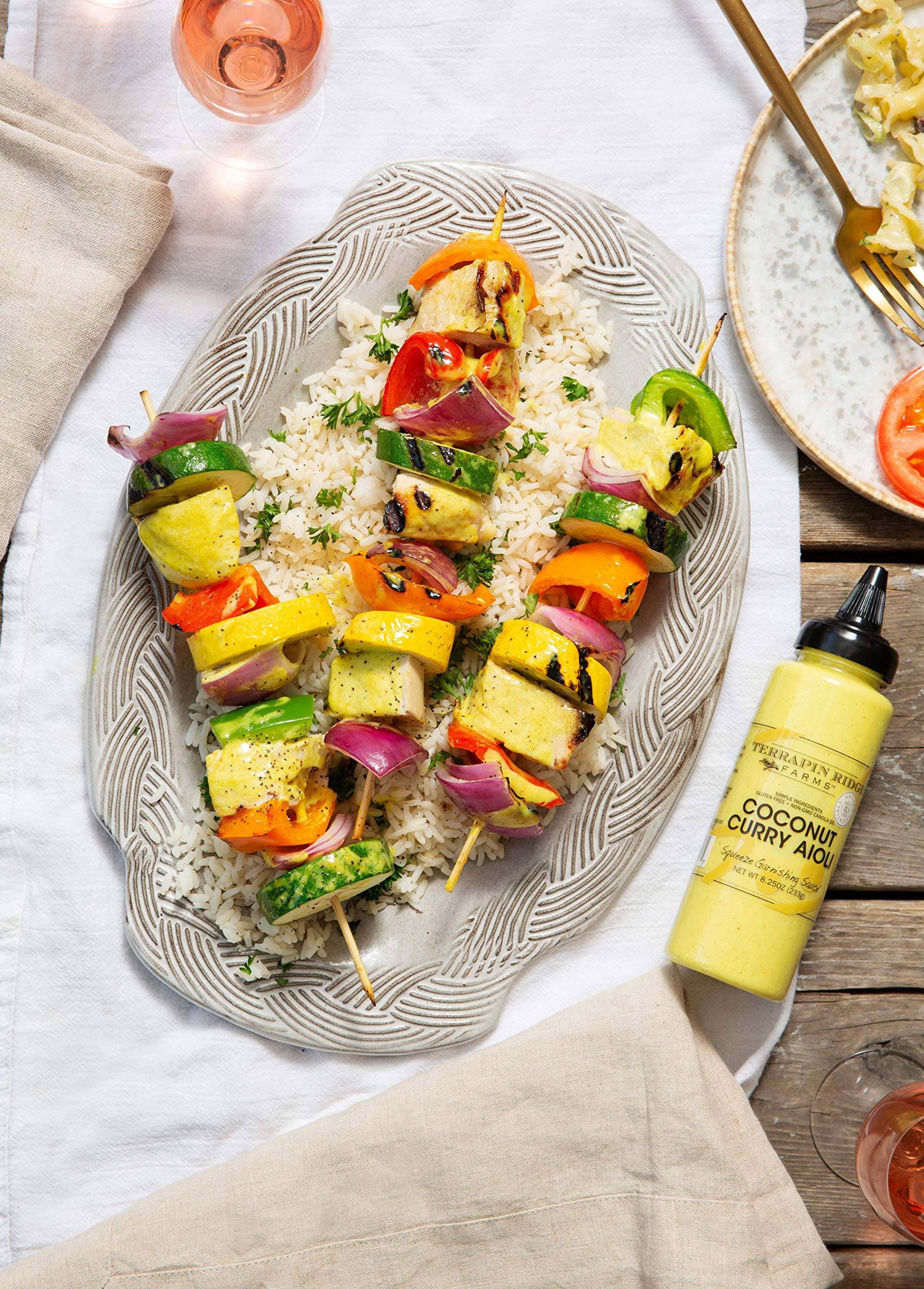Pouring Terrapin Ridge coconut curry aioli for bold, versatile flavor on dishes