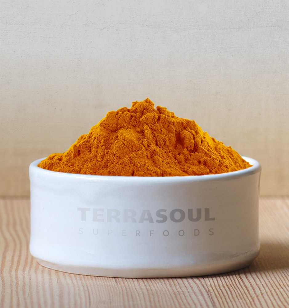 Terrasoul Turmeric Powder in a pot, highlighting its rich color for stews.