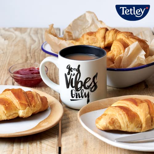 Pouring Tetley decaf tea into a cup with a comforting aroma.