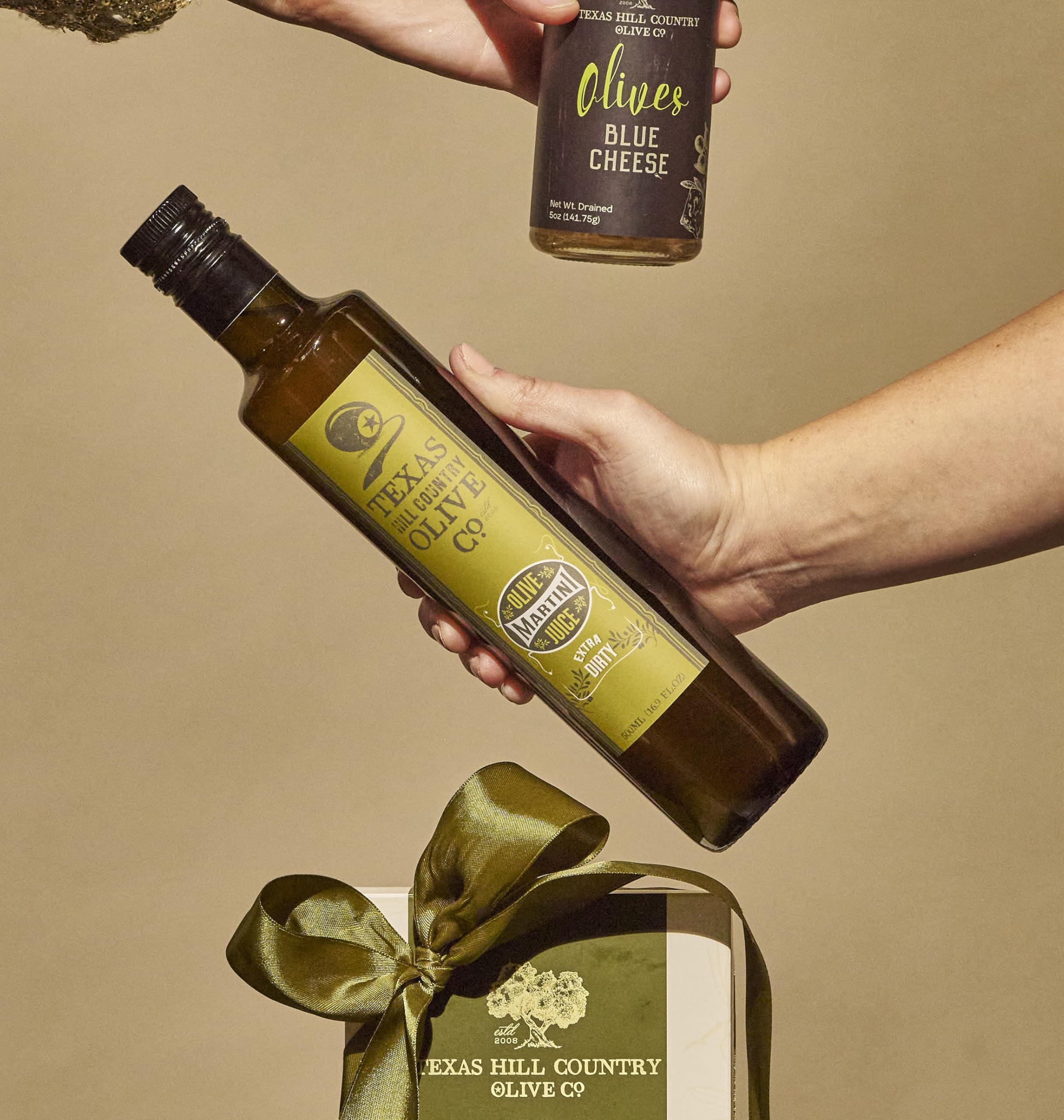 Texas Hill Country Olive Co. Martini glass with brine hints at cocktail customization.