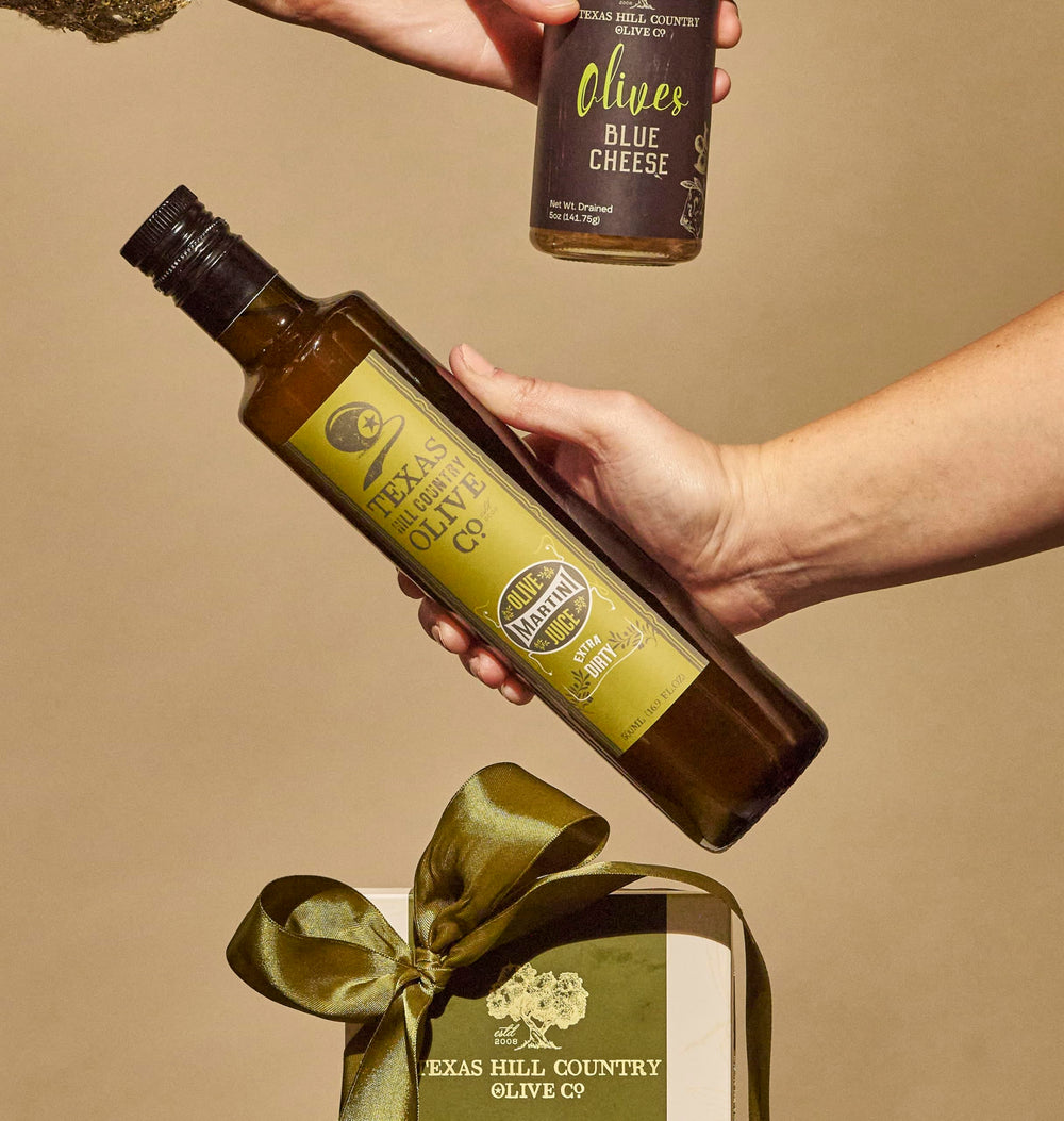 Texas Hill Country Olive Co. Martini glass with brine hints at cocktail customization.