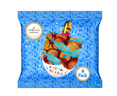 Milk chocolate gelt coins closeup highlighting smooth texture for tasty treats.