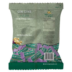 Whole ginger root beside Gin Gins package emphasizes fresh ginger content.