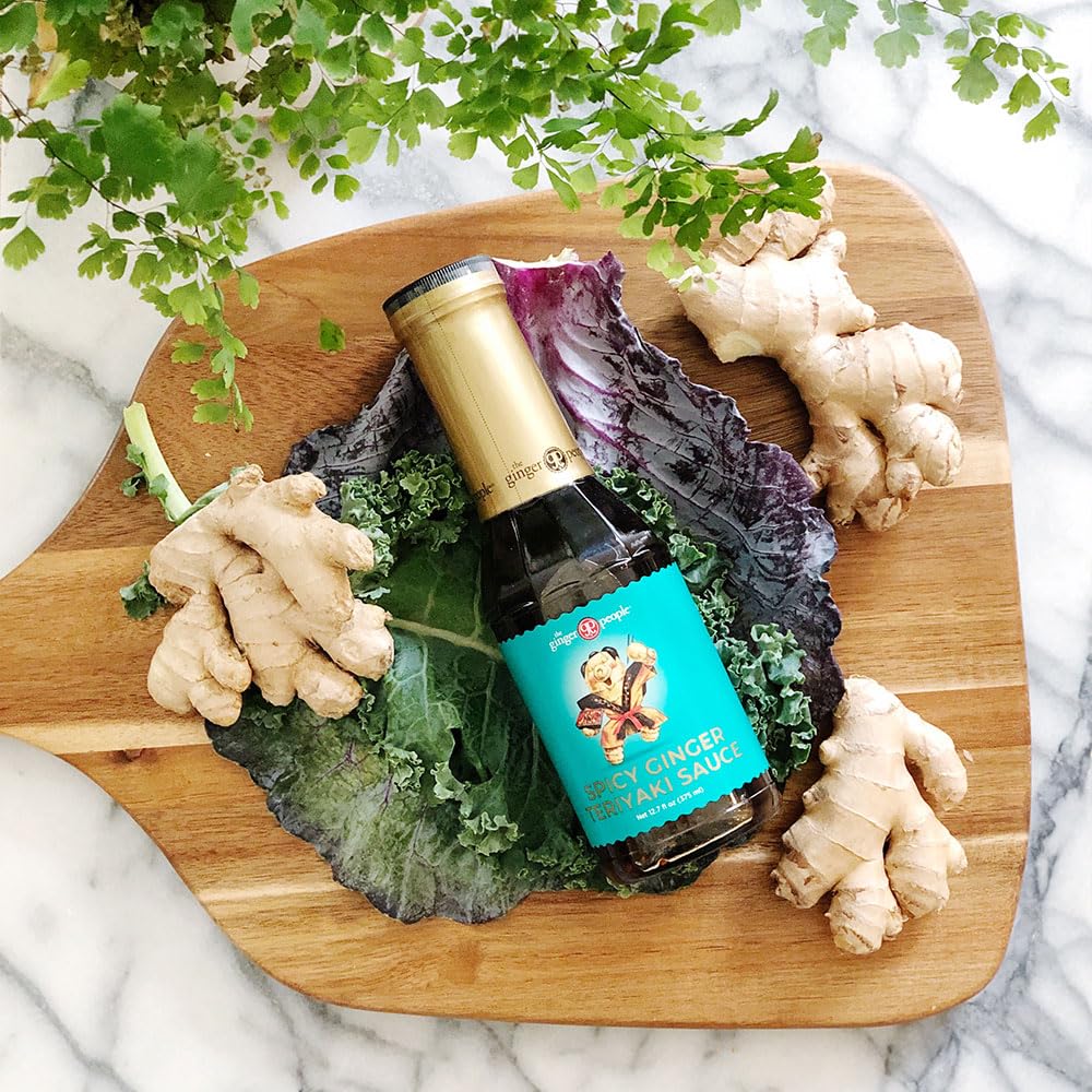 Pouring The Ginger People Spicy Ginger Teriyaki over a sizzling stir-fry.