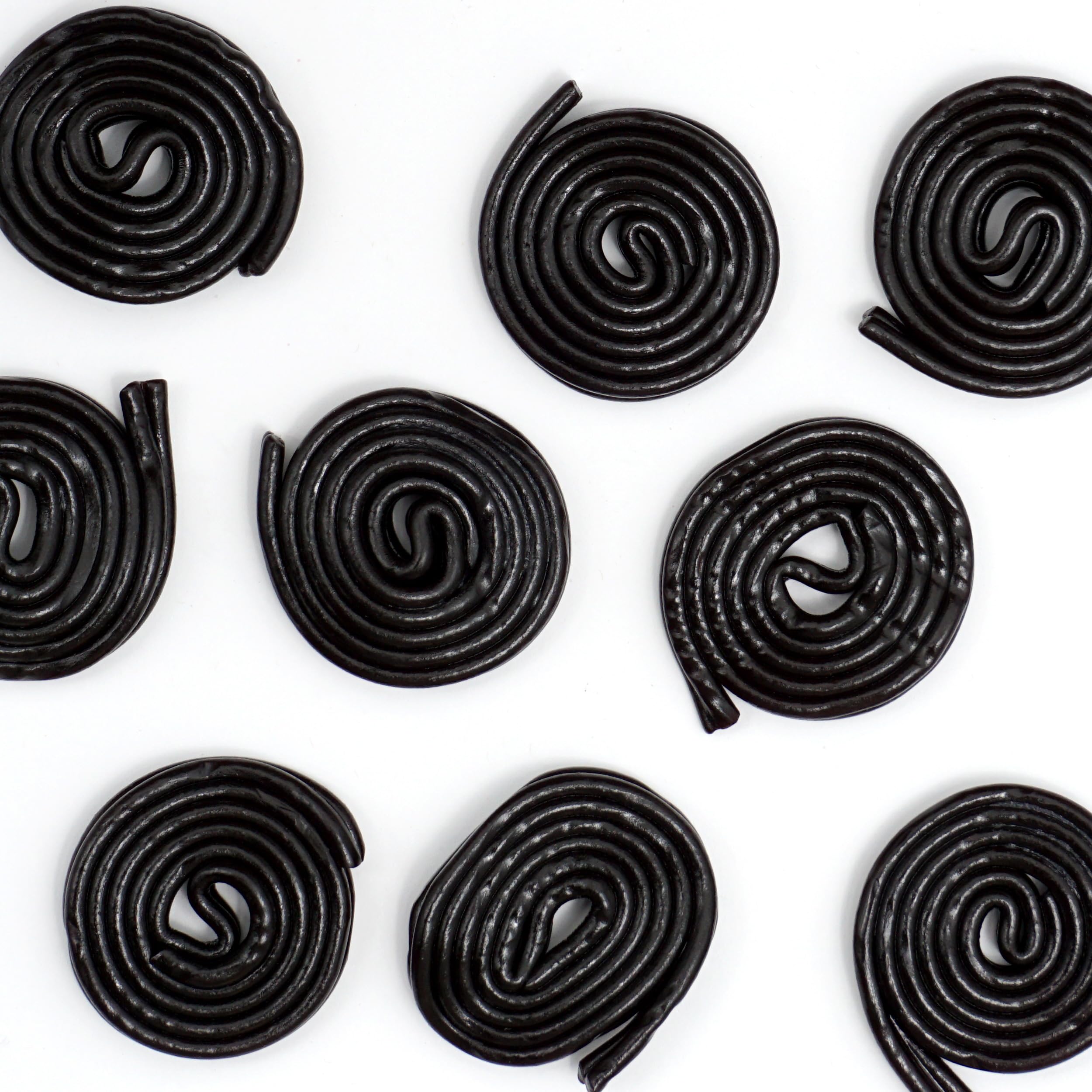 Licorice wheels beside coffee or tea for a satisfying afternoon treat.