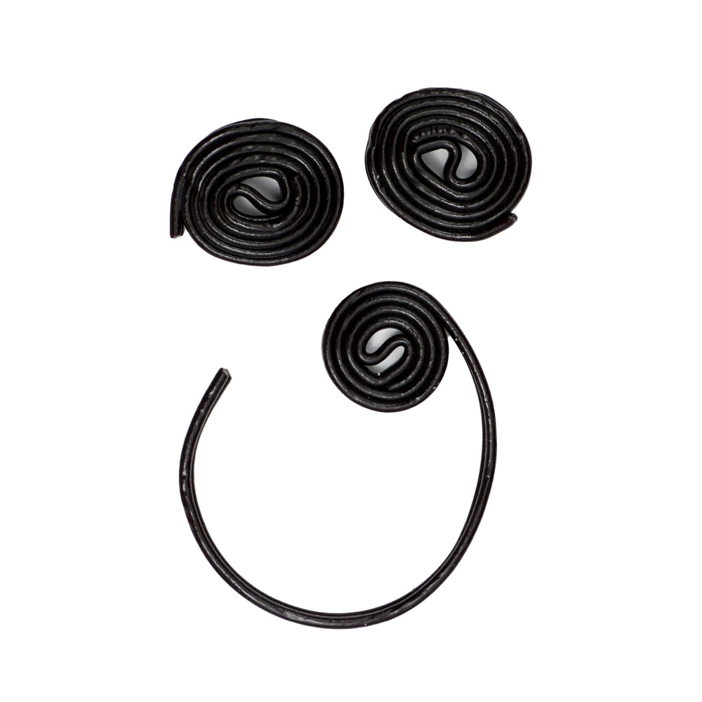 Hands holding a Broadway Licorice Wheel, convenient for on-the-go snacking and sharing.