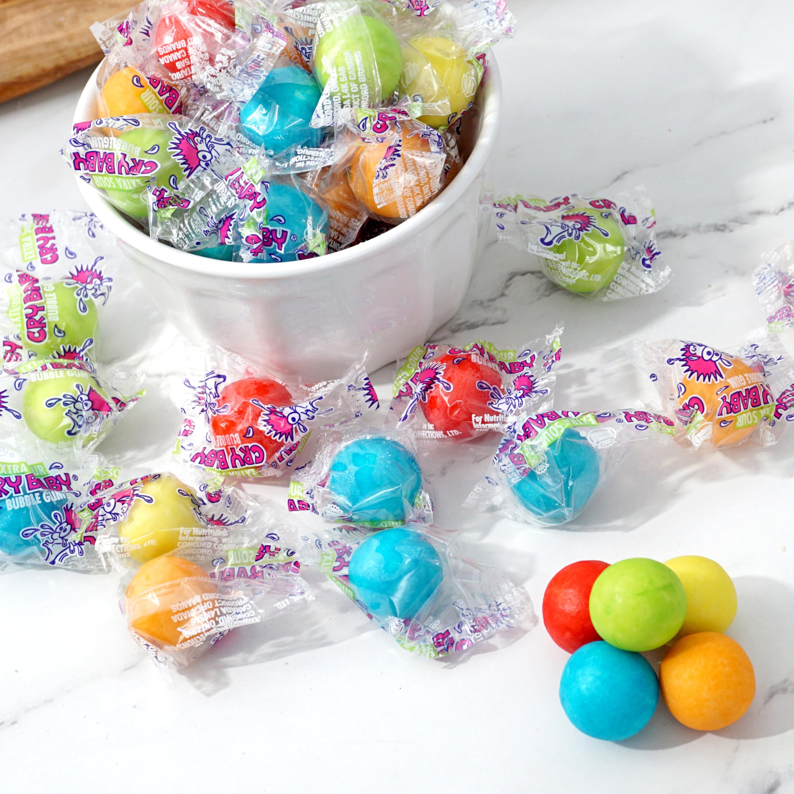 The Hampton Cry Baby Extra Sour Gum Balls open bag on table shows colorful gumballs for celebrations