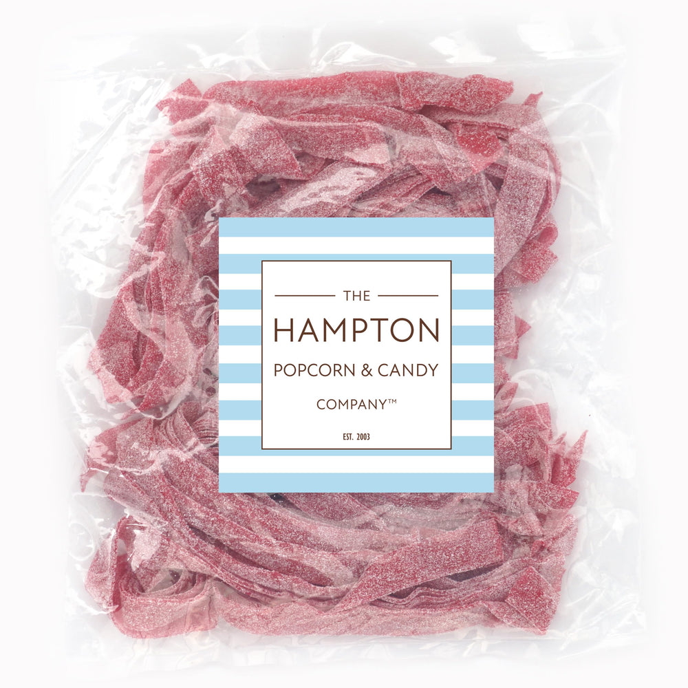 The Hampton Cherry Sour Belt closeup shows chewy texture and vibrant red color.