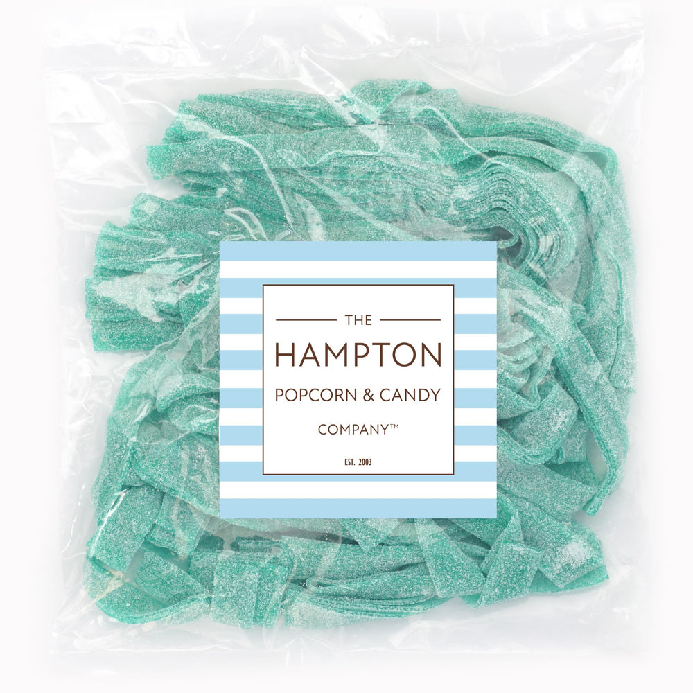 Closeup of Green Apple Sour Belts from The Hampton, showing glossy green ribbons.