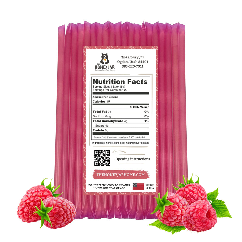 The Honey Jar raspberry honey stick ready to squeeze into a cup of tea.