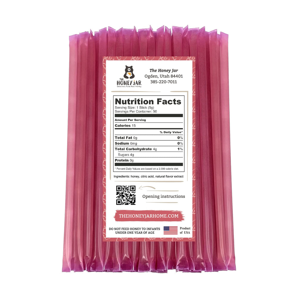 The Honey Jar Raspberry honey stick beside coffee for quick natural sweetness.