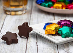 The Madelaine 8 oz bag of dark chocolate stars ready for sharing