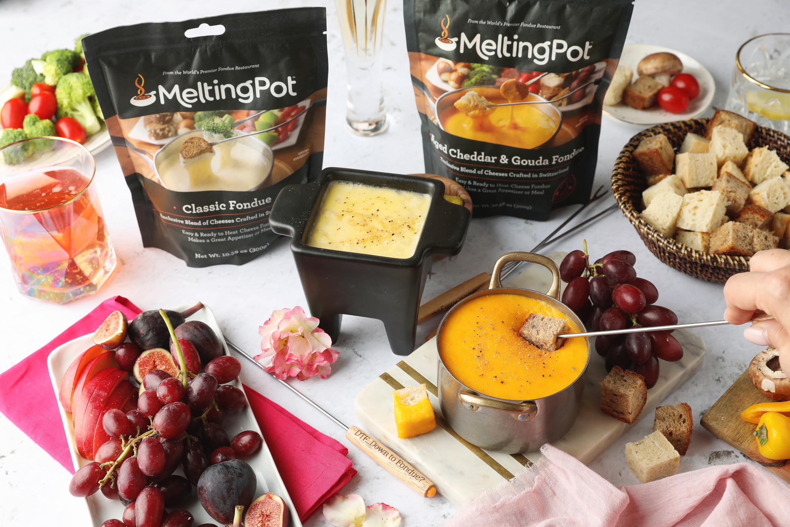 The Melting Pot ingredients close-up shows garlic, white wine, and herbs.