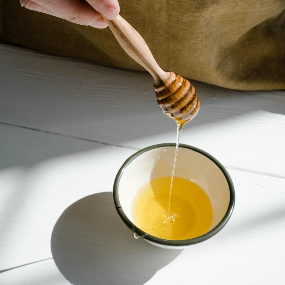 Pouring raw honey from bulk pail, perfect for recipes