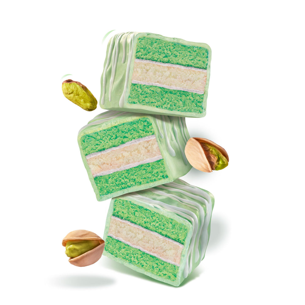 CakeBites Pistachio cross-section with icing and vanilla cream, showcasing layered flavors