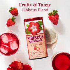 The Republic of Tea hibiscus strawberry tea bags with hibiscus petals ready to steep.