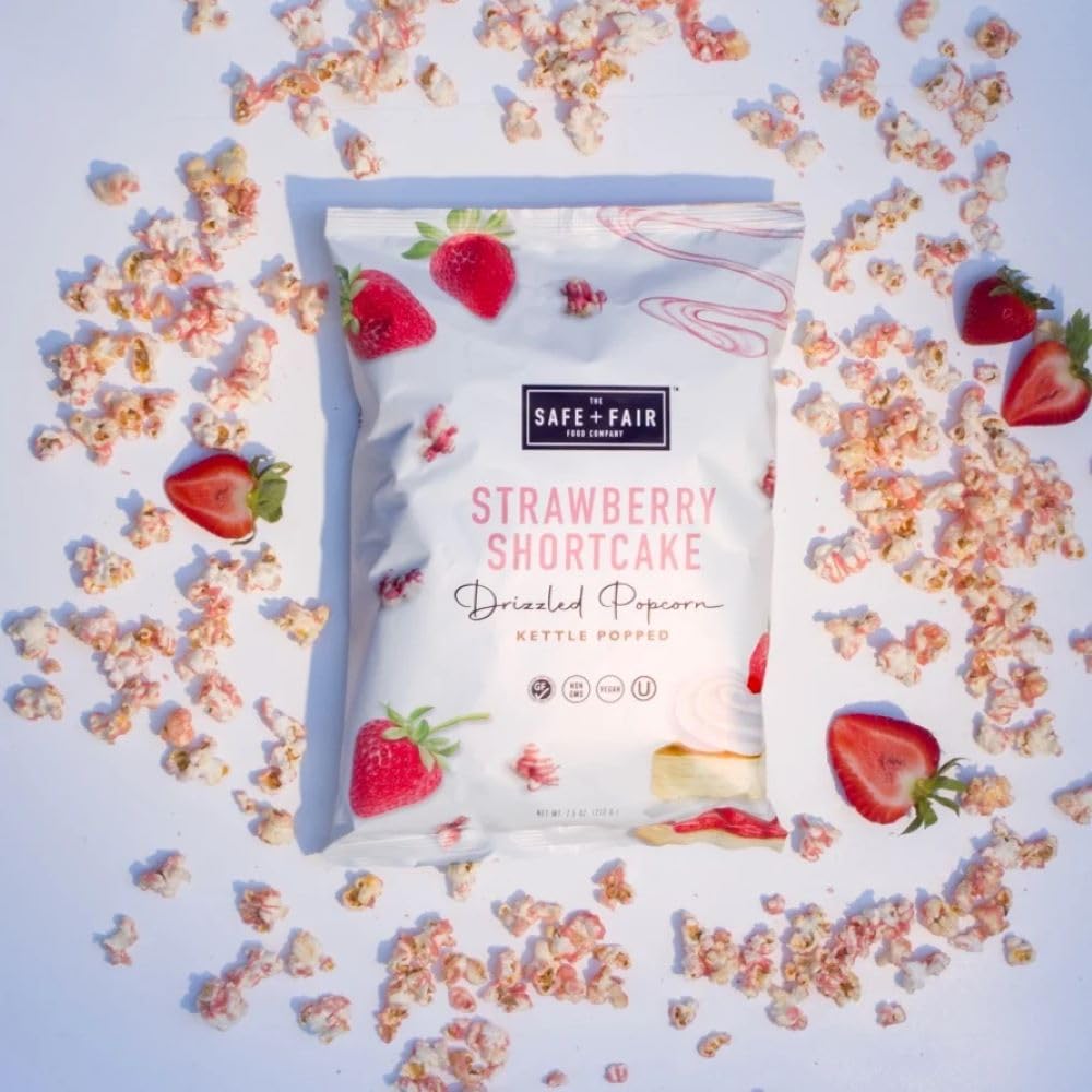 The Safe + Fair Strawberry Shortcake Drizzled Kettle Corn packaging shines on shelves.
