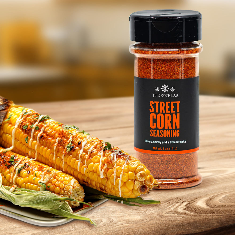Grilled corn sprinkled with The Spice Lab elote seasoning for bold flavor
