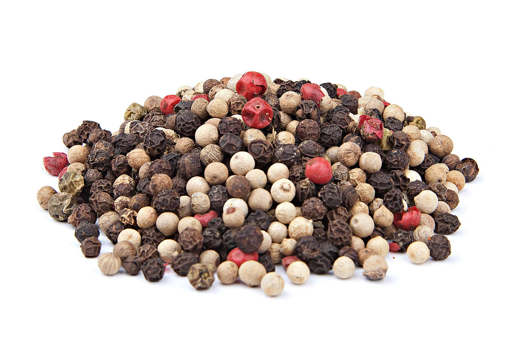 Tabletop scene shows The Spice Way Rainbow Peppercorn Blend elevating everyday meals.