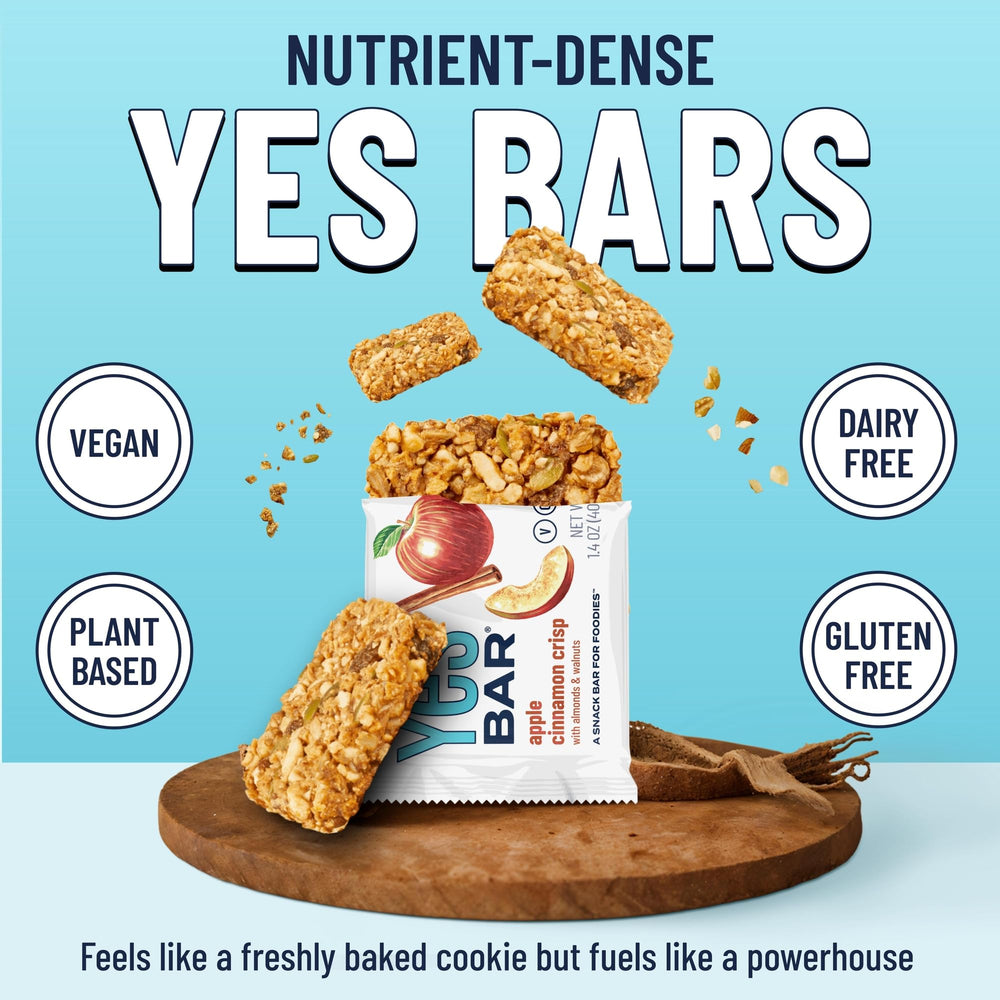 The YES Bar Apple Cinnamon bars on a natural backdrop emphasize wholesome ingredients for clean snacking.