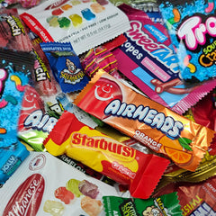 Nerds and Gummy Bears in a colorful fruit candy selection for snacking.