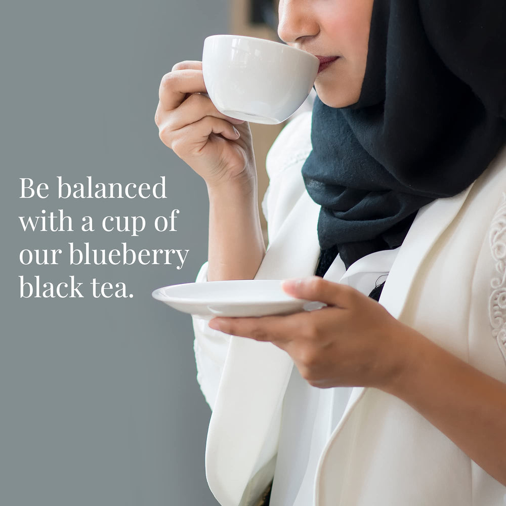 Wild Blueberry Tea bags stacked beside the tin for quick, flavorful cups.