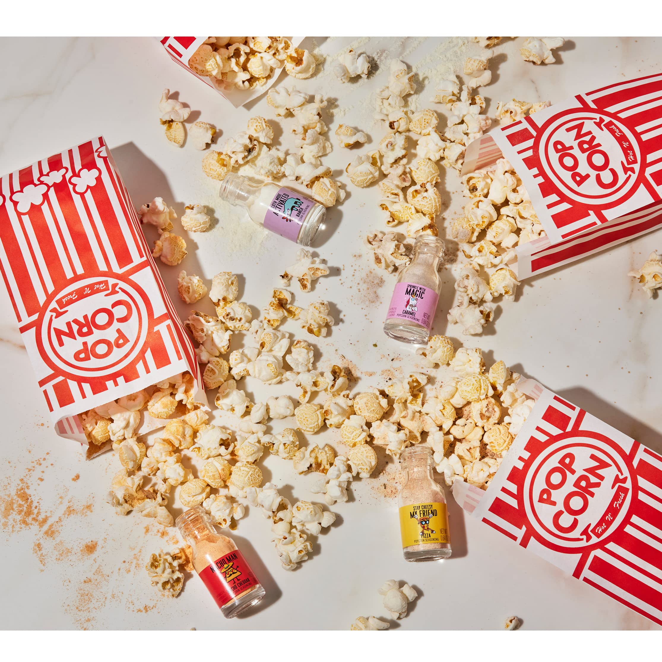 Thoughtfully Gourmet seasoning jars arranged for easy sprinkling on popcorn