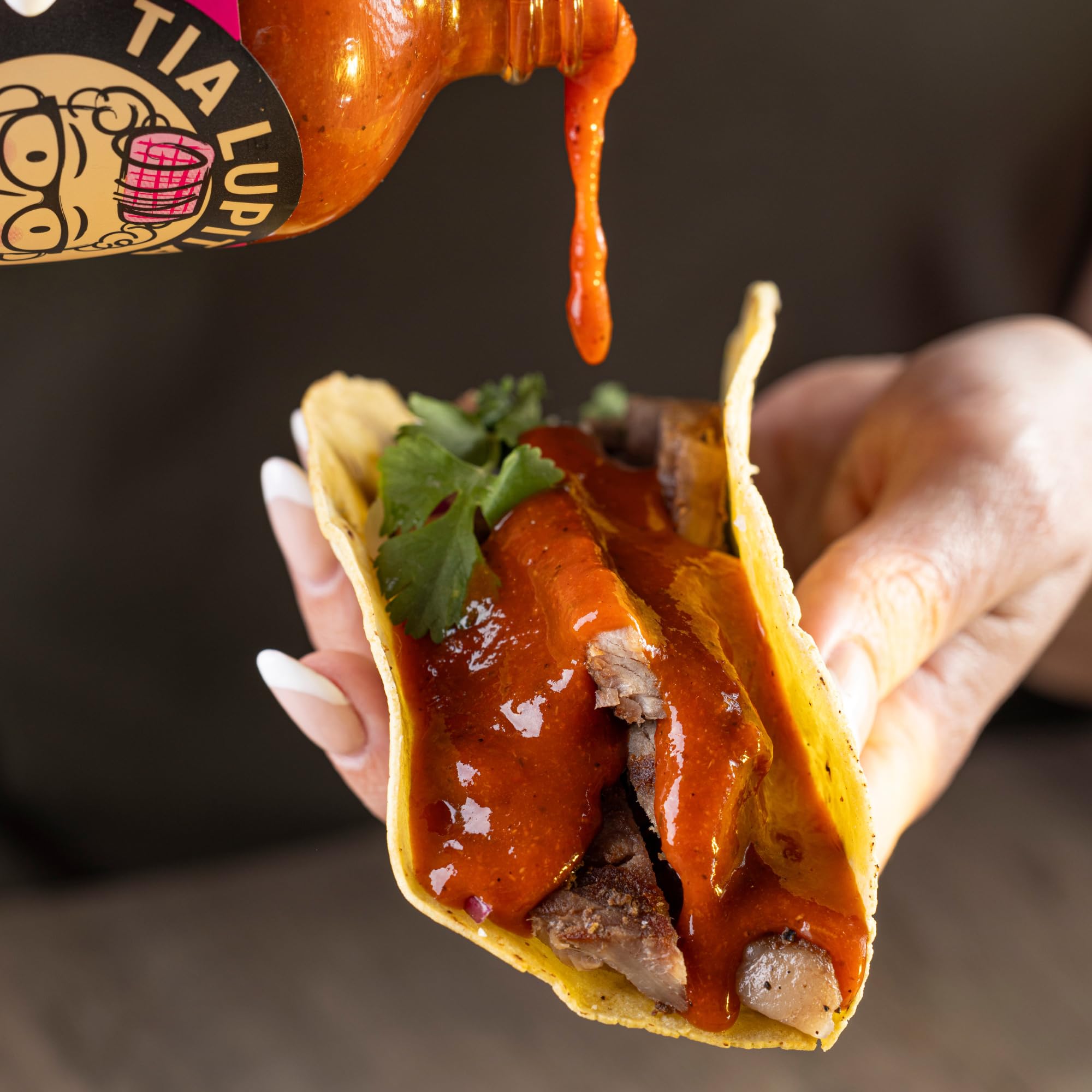 TIA LUPITA hot sauce bottle with tacos, versatile finishing touch