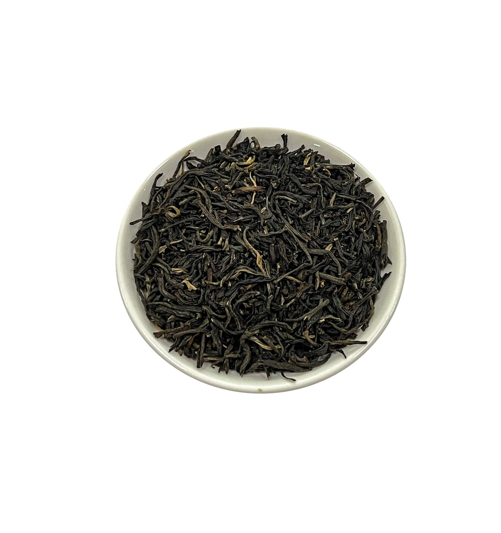 Close-up of Tian Hu Shan black tea leaves shows premium whole leaves.