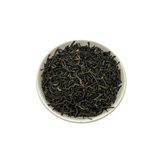 Close-up of Tian Hu Shan black tea leaves shows premium whole leaves.
