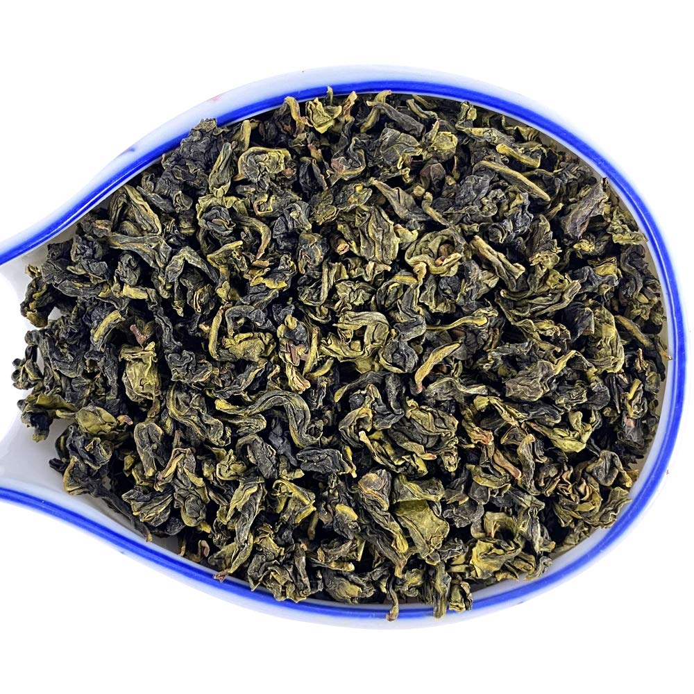 Brewed Ti Kuan Yin in a glass cup reveals amber color and delicate layers.