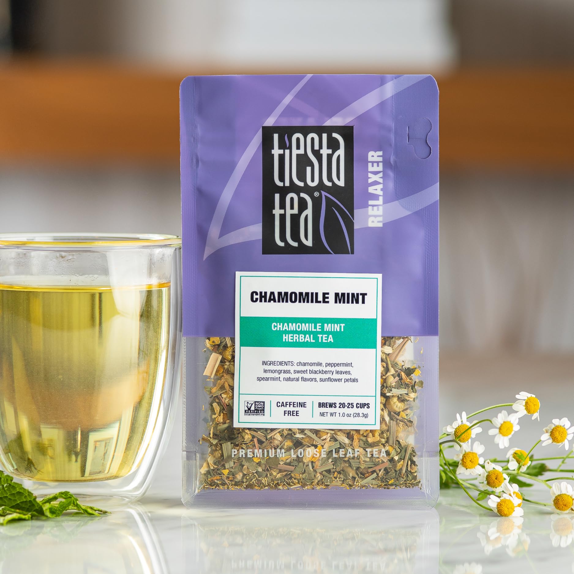 Chamomile Mint loose leaf being scooped for accurate measurement.