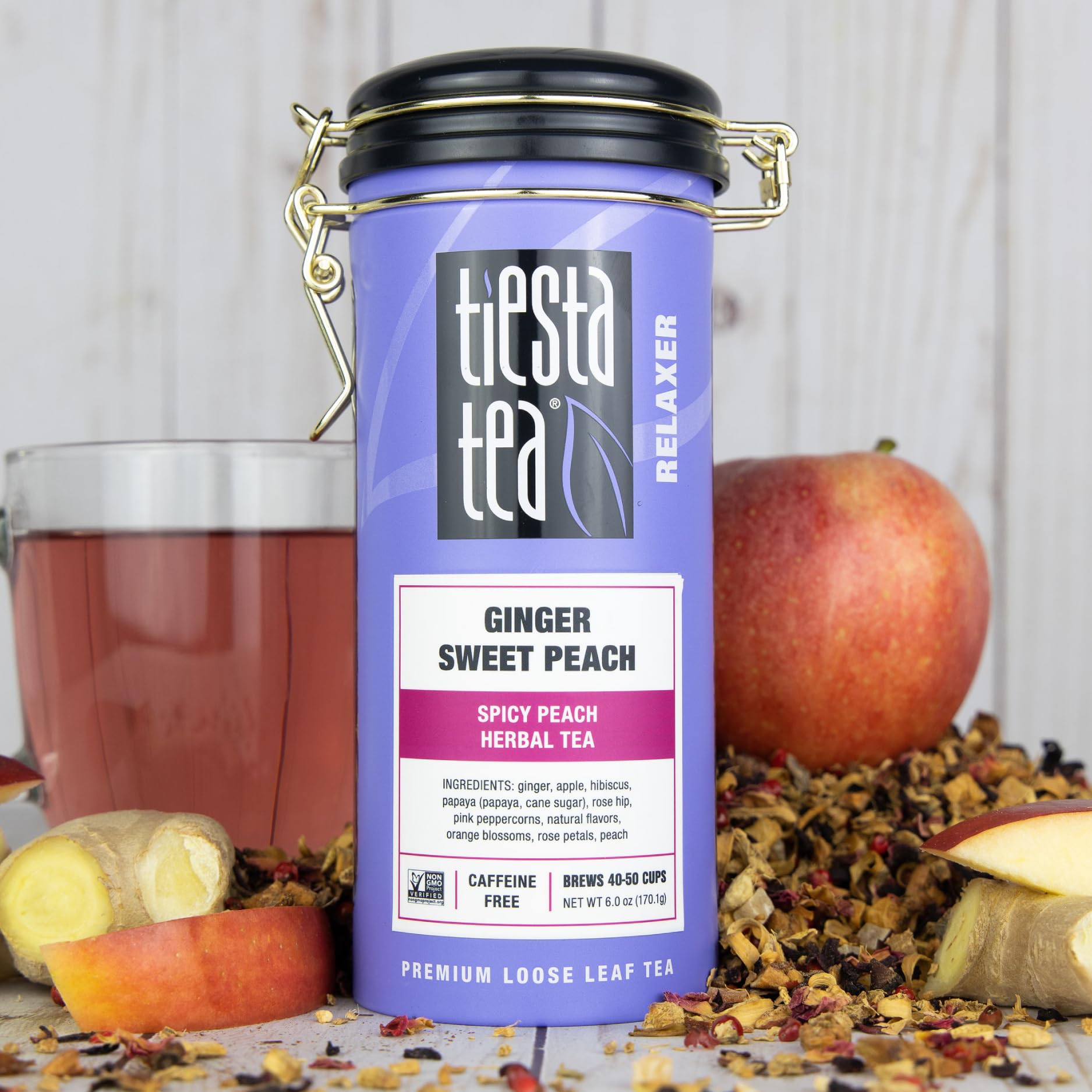 Tiesta Tea Ginger Sweet Peach tin with cup, perfect for refreshing iced tea.