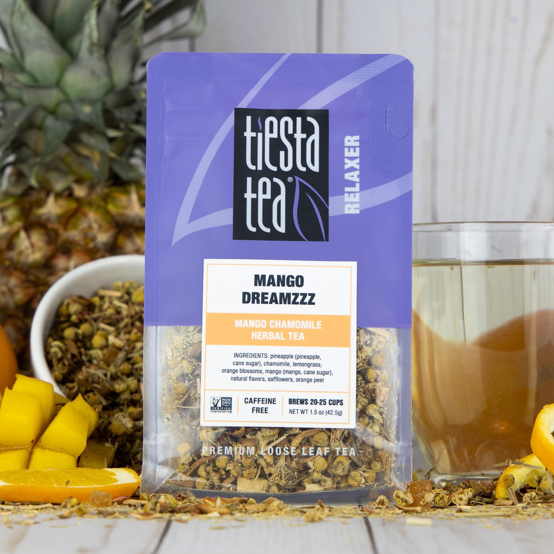 Tiesta Tea Mango Dreamzzz Chamomile being scooped for steeping