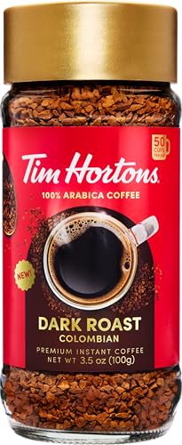 Tim Hortons Dark Roast instant coffee being poured into a cup for quick enjoyment
