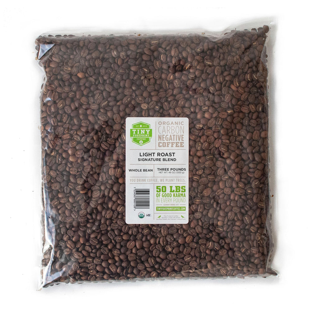 Tiny Footprint Coffee Signature Blend Light Roast beans ready for a bright, citrus-forward morning brew