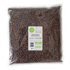Tiny Footprint Coffee Signature Blend Light Roast beans ready for a bright, citrus-forward morning brew