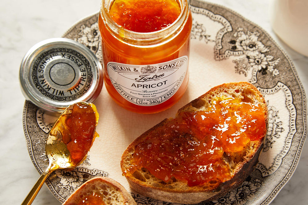 Tiptree Apricot Preserve side view showing jar and label.
