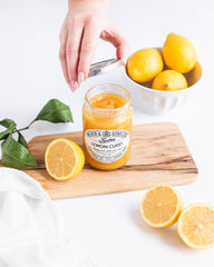 Tiptree Lemon Curd being swirled into yogurt or frostings for tangy depth.