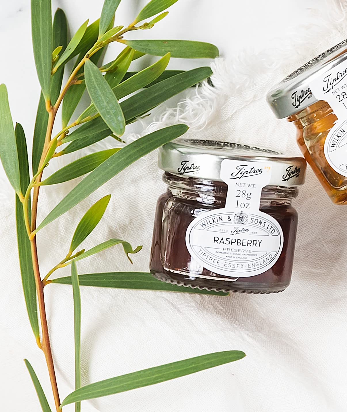 Tiptree Raspberry Preserve Minis 72-pack display, ideal for gifting.