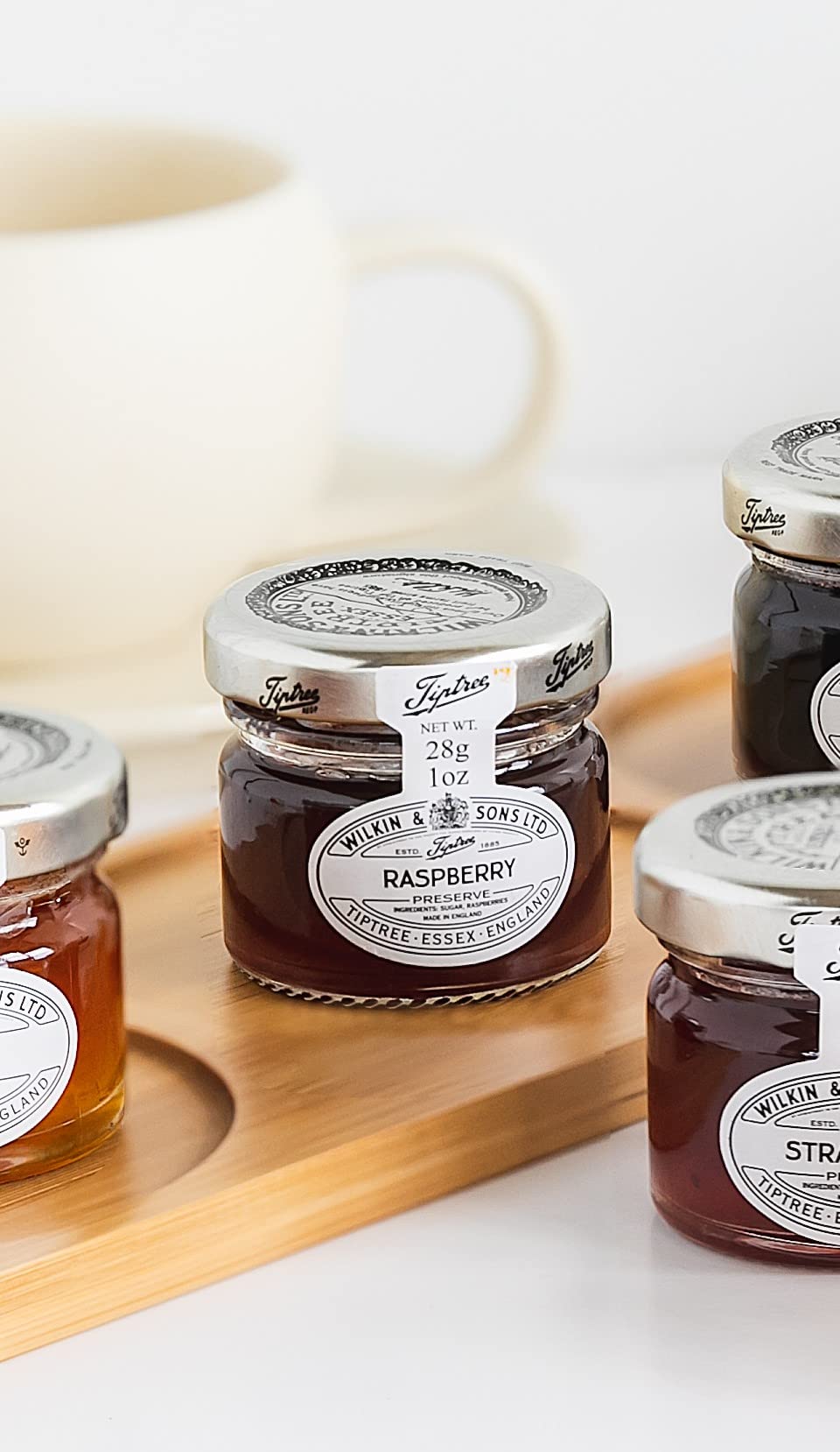 Close-up of Tiptree Raspberry Preserve Minis with vibrant berry pieces.
