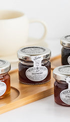Close-up of Tiptree Raspberry Preserve Minis with vibrant berry pieces.