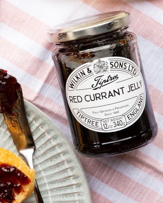 Tiptree red currant jelly with cheese and biscuits pairing close-up illustrating versatile serving ideas.