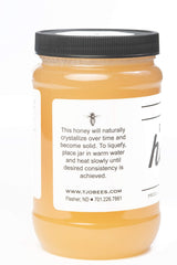 TJO Bees raw honey being poured, showcasing golden liquid ideal for tea.