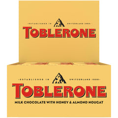 Toblerone Milk Chocolate Bar triangle peak close-up reveals honey almond nougat inside, ideal for sharing.