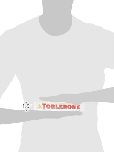 Toblerone White Chocolate on a desk setup beside a coffee for an afternoon treat