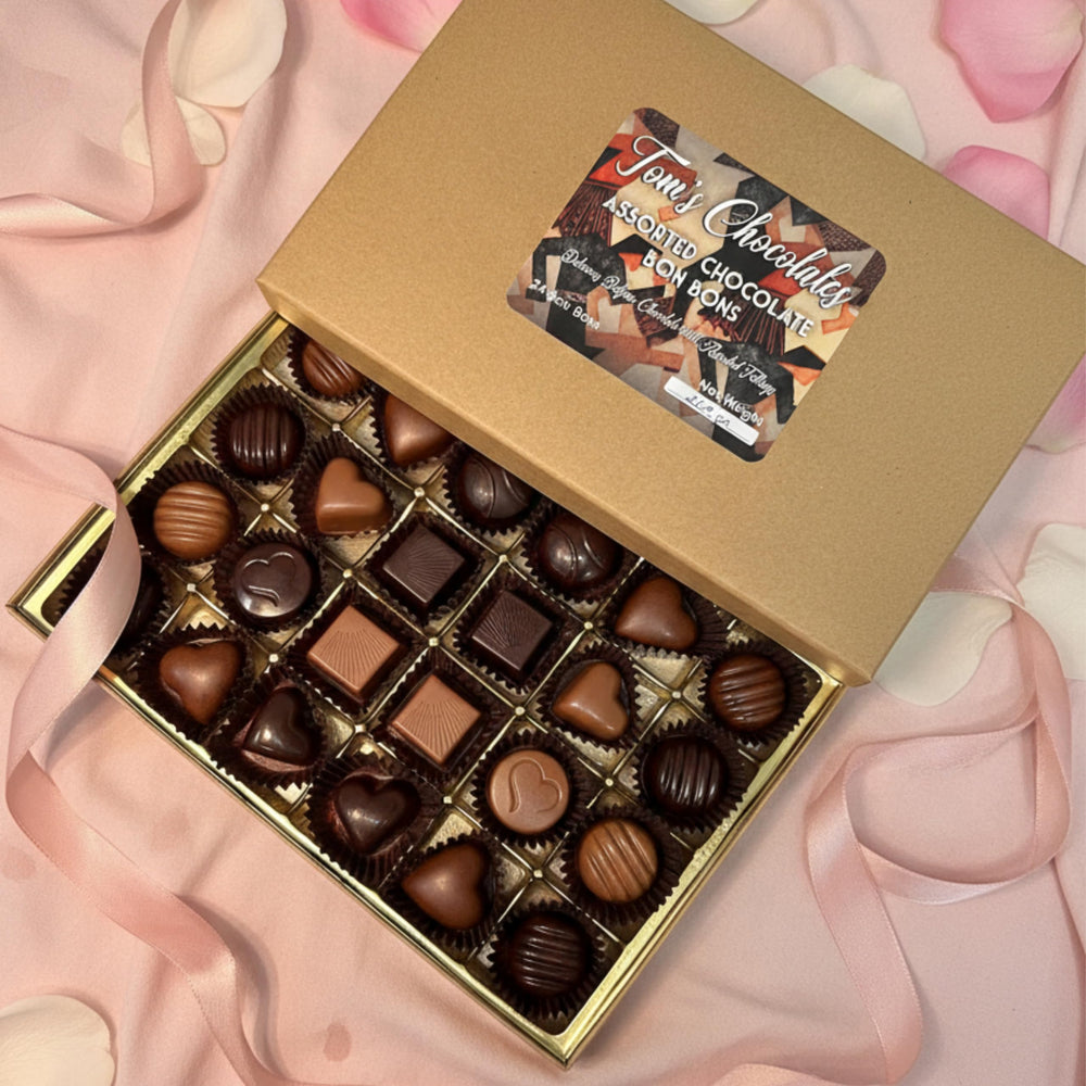 Nut-filled hazelnut and almond bonbons close-up with glossy chocolate shells
